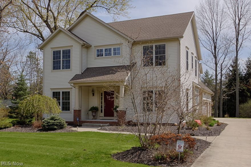 Stunning 2005 custom built home will take your breath away from the minute you step onto the charming covered front porch and inside the two-story Foyer with hrdwd flrs and a wrought iron staircase. Off the Foyer is a private office/den w/charming double French Doors. Enter into the lovely Great Room featuring extensive custom moldings and a wall of built-ins, a gas burning Fireplace, more hrdwd flrs. The Great Room opens to a magnificent Kitchen with a large center island, gorgeous granite and hardwood floors. A formal dining room off the kitchen boasts hardwood floors and more custom moldings. Glass Sliding Doors lead from the Great Room/Kitchen to a wonderful outdoor stamped concrete patio. A charming Powder Rm and convenient Laundry Rm complete the 1st fl. Enter through double doors to the impressive Owner's Suite w/ a Grand Master Bath, double sinks, large jetted tub and a glass block, walk-in waterfall shower.  The Master boasts an 11x10 walk-in Closet. The upstairs includes thre