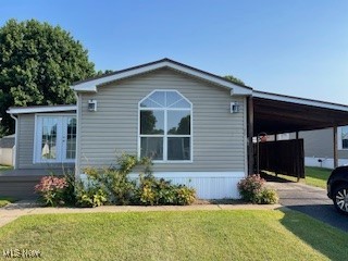 Well maintained and move in ready is this three bedroom two bath mobile home with many extras. This mobile home is located in a well maintained mobile home park in West Lafayette, OH. Inside you will find a newly renovated master bathroom with a walk in tiled shower, double French doors that open off of the master bedroom onto a 24 x 10 deck, and double French doors that open into a built on 10 x 35 sunroom with a 8x10 deck located out of the second set of French doors. The double French doors located off of the master bedroom is surrounded by flowering shrubs to provide privacy. The mobile home comes with an attached 10 x 45 carport and two buildings 10 x 16 and 10 x 20 both with lofts and electric. A 3 ton central air unit was installed in August of 2023. The kitchen, living room, and sunroom have newly installed floating floors. Take in the all four seasons from the sunroom as it is surrounded with windows.