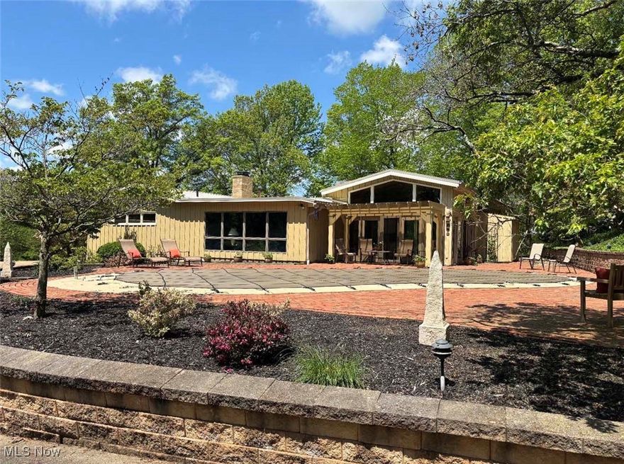 Very clean, well-built, one-owner mid-century contemporary ranch on 4.2 acres in Minerva, Ohio. Hilltop setting with terrific views, woods to the rear. The home has 2,576 sq ft on the main level with an open floor plan. Large kitchen with appliances and solid surface countertops opens to a large family room with a fireplace. Formal dining room and living room with fireplace and cathedral ceilings. Attached rear sunroom overlooking a nice inground pool. Main floor laundry, 2-car attached garage with half bath for pool guests. The lower level is finished with 934 sq ft, rec room, and a full bath. Brick paver patio around the pool, storage shed, 20 x 20 barn with overhead door, and two concrete driveways. Vacuflow system, 200 amp breaker electric, and public water and sewer. Awesome property, well-maintained and ready for the new owner!