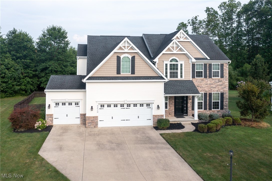 Prepare to be moved! This exceptionally updated four bedroom, two full and two half bath Colonial was built in 2014 and thoughtfully remodeled in 2020, offering the perfect blend of modern comfort and timeless Craftsman-style curb appeal. Inside, you’ll find a spacious first floor featuring a large kitchen boasting black cherry cabinetry with an oversized center island with granite counters and stainless appliances which stay, vaulted morning room, —ideal for gatherings and everyday living. The first floor also includes a formal dining room and private office (or potential 5th bedroom) and a warm, inviting layout that flows seamlessly throughout. The owner’s suite is a true retreat, complete with a sitting area or ensuite nursery, dual walk-in closets, and a spa-like bath. Three additional bedrooms are generously sized and well-appointed along with laundry complete the second floor. The fully finished basement provides exceptional additional living space, including a recreation area and a great gym space. Outdoor living shines here with a fenced estate lot backing to trees, a composite deck, stamped concrete patio, and a built-in fire pit—perfect for relaxing or entertaining. The 3-car garage provides plenty of storage and convenience. Timber Ridge is a sought-after community with only one way in and out, creating a private, neighborhood feel while still being close to downtown North Ridgeville and all amenities. This home truly has it all—space, updates, style, and location!