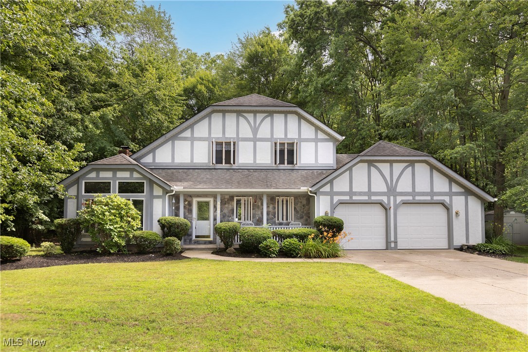 Tucked away at the end of a peaceful cul-de-sac, this stunning 3-bedroom, 3-full-bath Tudor home sits on a generous .91-acre lot, offering nearly a full acre of privacy and space with a walking path and stamped concrete patio. From the moment you arrive, you’ll be captivated by the tranquil setting and beautifully maintained surroundings.
Inside, soaring vaulted ceilings create an airy, open atmosphere throughout the main living spaces, including a dedicated home office that’s perfect for remote work. Relax in the open concept great room with a gas fireplace that leads to the heart of the home, the gourmet kitchen, equipped with premium finishes and designed for both serious cooking and stylish entertaining.
Enjoy sun-filled mornings and cozy evenings in the inviting sunroom, a perfect extension of your living space that overlooks the expansive wooded backyard. Each of the three full bathrooms is tastefully updated and thoughtfully placed for comfort and convenience.- No HOA living! And a home warranty included. Garage includes both hot and cold water and a drain.
Located in desirable North Ridgeville, this home offers a rare combination of privacy, space, and sophisticated living—perfect for those seeking comfort without compromise. 3.5 miles to I-90 and shopping.