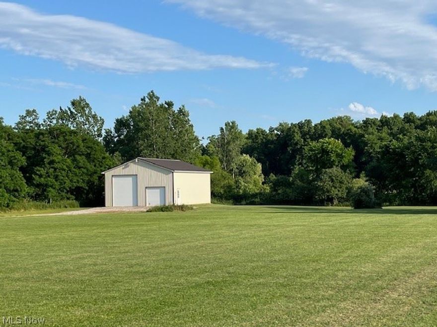Nice building lot with a newer 32' x 44' metal pole building. The building has 4" concrete, 14' high door, insulated doors and roof. Public water is on the property. 12/23 new water line and new tap installed. The tap has been paid. Electric in the building. The building is plumbed for 1/2 bath. The driveway is in. Woods in the back.