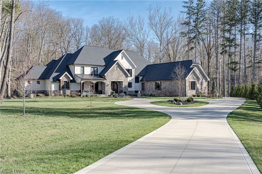 Perfectly positioned on 7.6 park-like acres on the Yellow Creek, sits this remarkable contemporary colonial, custom designed by Gem and Clay interiors. 3903 Granger represents a flawless blend of stunning interior design with the breathtaking nature preserve that surrounds it. Nearly every room in this impeccable 2020-built home features views of a serene waterfall, complemented by high-end finishes, and a harmonious blend of colors and textures. A circular drive leads to the welcoming front entrance where double doors open into a gorgeous foyer. Straight ahead, the stunning great room boasts a 2-story ceiling, a stone fireplace, and a full wall of windows that drench the space with light. The great room flows seamlessly into a cozy sitting room and to the inviting formal dining room. The adjacent chef’s kitchen features top-of-the-line appliances, a huge center island, and an elegant wood-paneled ceiling. Off of the kitchen is a butler's pantry with additional prep space and a walk-in pantry. On the other side of the home, the first-floor primary suite leaves nothing to be desired. Here you will find a generous bedroom, a spa-like ensuite bath, a huge dressing room, a cozy office, and a hidden reading room. Plus, right across the hall is a home office with a separate entrance and a set of stairs into the lower level. Two powder rooms and a laundry room complete the first floor. Upstairs, there are three bedroom suites, a crafting room, and a conference room! The walk-out lower level provides many opportunities to relax and unwind. Here you will find a bar, wine cellar, music room, fitness room, media room, golf simulator, and a guest suite. Outside, there is a huge back deck, a private deck for the primary suite, and two patios! For the outdoor enthusiast you can kayak in the reservoir, fish in the creek, or just relax to the tranquil sound of the falling water. The lifestyle of luxury and comfort that 3903 Granger Rd presents is unmatched.