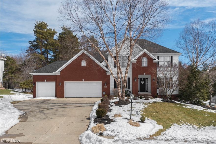 This partial brick exterior colonial home has been exceptionally maintained and sits on .60 acres of private wooded land. Enter into the light filled foyer where you will find a cozy lounging area, and a formal dining room on either side of you. The main living space is open and laid out with entertaining in mind. The eat-in kitchen flows directly into the family room and is fully equipped with a breakfast bar, large farmhouse sink, beautiful white cabinetry, and modern light fixtures. This space has direct access to the back deck through sliding glass doors. Upstairs you will see that double doors open up to the vaulted master suite. This spacious suite features plush carpeting, an expansive walk-in closet, and a luxurious master bath with jacuzzi and double vanity. The additional 3 bedrooms are full of natural light and have ample closet space. The fully finished basement is every homeowner's dream and boasts a fully equipped kitchenette with bar seating, recessed lighting, and parti