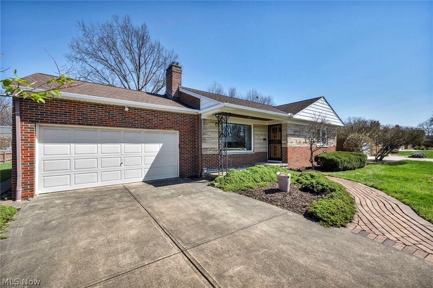 Welcome to this beautifully maintained all-brick ranch nestled in a prime North Olmsted location just minutes from Great Northern Mall, Metroparks trails, and quick access to I-480 and I-90 for an easy commute. Offering timeless charm and pride of ownership throughout, this home features a welcoming front porch and newer concrete driveway that set the tone from the start. Step inside to a true foyer entry—rare for a ranch—providing a warm and functional transition into the home. The spacious living room is filled with natural light from a large picturesque window and anchored by a classic wood-burning fireplace, flowing seamlessly into the formal dining room—perfect for everyday living or entertaining. Gorgeous, gleaming original hardwood floors span the entire main level, complemented by clean baseboards and molding that add character throughout. Just off the dining room, enjoy a cozy enclosed sun porch with a ceiling fan and walls of windows overlooking the large, manicured, partially fenced backyard with a concrete patio—ideal for relaxing or hosting. The kitchen offers abundant cabinet and countertop space, room for an eat-in area, and comes fully equipped with a dishwasher, microwave, range, and refrigerator. A conveniently located and updated powder room sits just off the kitchen. Two generously sized bedrooms feature ceiling fans, ample closet space, and great natural light, while the full bath showcases timeless mosaic tile flooring. The basement expands your living space with a partially finished rec room featuring a second fireplace, plus a large unfinished area for storage along with a newer washer and dryer.  Additional highlights include Andersen windows and doors, a 200-amp electrical panel, and a home that has been exceptionally cared for over the years. This is a rare opportunity to own a solid, character-filled ranch in a highly convenient and sought-after location.