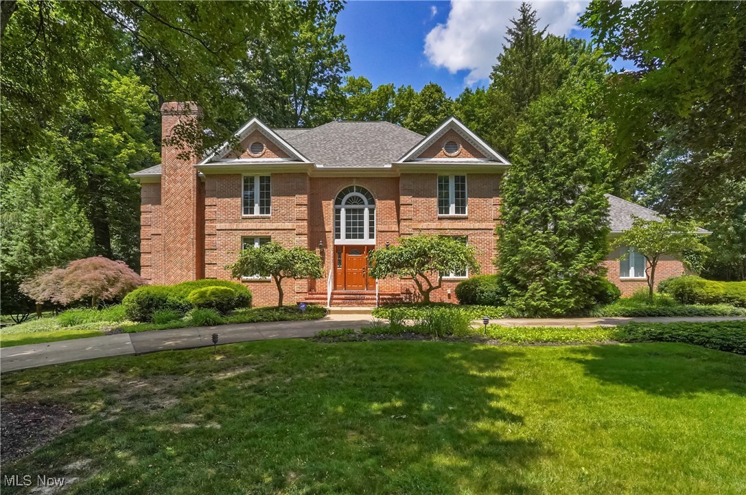 Stately, all brick Georgian colonial nestled on 1+ wooded acres in desirable Crystal Shores development of Bath Township presents superior craftsmanship and design throughout. Welcoming two story boasts hardwood floors, Palladian windows, open staircase, and dental crown molding. Formal living and dining rooms feature neutral décor, stacked crown molding, and hardwood floors. Spacious kitchen offers all appliances, granite counters, center island, planning station, bayed eating area with French doors to deck, and overlooks the family room. Engaging family room features a striking wall of glass, a dramatic floor-to-ceiling brick fireplace flanked by custom built-ins including a wet bar with wine rack—and a door leading to an adjacent office with built-in bookshelves and its own brick fireplace. First floor laundry room and guest bath conveniently located. French doors open to the spacious primary suite on second floor, featuring a cozy sitting area, two closets, and a vaulted glamour bath with a skylight and jetted tub. An additional three generous sized bedrooms, all en-suite complete the second floor. Partially finished lower level recreation room w/ wall of cabinetry. 3 car side load garage. Circular drive, Wood deck spans the entire length of home. Wooded backdrop. Notables include A/C 3 yrs, furnace 1 yr, new ceiling in garage. Close proximity to Wellness Center/Lifestyles, expressways, shopping, and cultural opportunities.