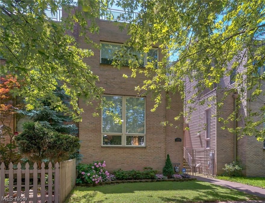 LOCATION!  Don't miss this chic Tremont Townhouse!  Three to four stories of wide open space lined in hardwood floors, soaring high ceilings, and walls of windows that flood natural light into the space.  First level houses your family room with cozy fireplace and tons of windows with the half bath.  Second floor boasts the updated kitchen with cherry custom cabinets, granite counter tops, and updated stainless steel appliances, all flowing into an open dining space with access to one of the attached outdoor decks.  Master and two additional bedrooms accompanied by two full bathrooms, and a separate laundry room make up their own area of the home for added privacy. Loft style office space currently rests on the top, fourth floor with access to the second attached outdoor deck with views of the city. Finished basement is perfect for a workout space, extra storage or living space!  Two car attached garage.  All your big ticket items have been updated: furnace, A/C, and hot water tank all