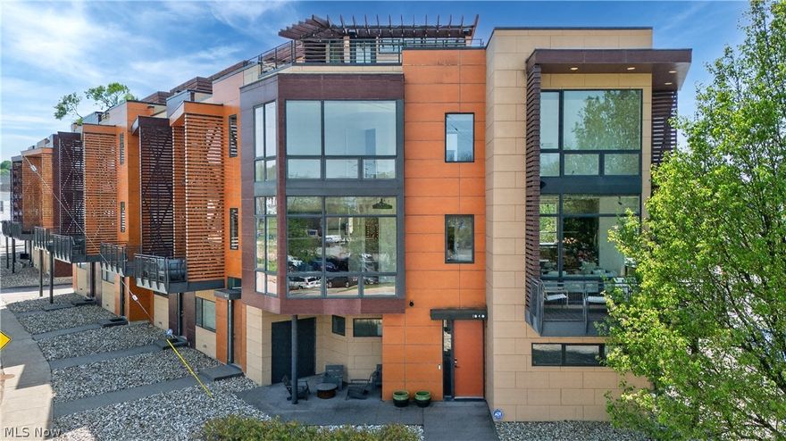 Luxury living takes center stage in this exceptional four-story townhome by Dimit Architects, perfectly set in the vibrant heart of Little Italy. With over 3,300 sq ft of thoughtfully designed space, this residence blends modern sophistication with panoramic city views—just minutes from Uptown Cleveland, Downtown Cleveland, Cedar Fairmount, and Coventry Village, placing the best of dining, culture, and entertainment right at your doorstep. Expansive 10-foot floor-to-ceiling windows flood the home with natural light, while over 1,000 sq ft of outdoor living space—including a stunning rooftop deck with a custom outdoor kitchen—creates an unparalleled setting for entertaining. The open-concept main level is anchored by a sleek chef’s kitchen featuring premium KitchenAid and Jenn-Air appliances, custom cabinetry, granite countertops, and a generous island designed for both everyday living and hosting. From the private wraparound balcony to the media lounge with fireplace and built-ins, every level offers elevated comfort and style. The owner’s suite serves as a true retreat with a spa-like bath, while additional bedrooms provide flexibility for guests or work-from-home needs. Complete with a heated two-car garage and refined finishes throughout, this turnkey residence delivers a rare blend of luxury, design, and unbeatable location.