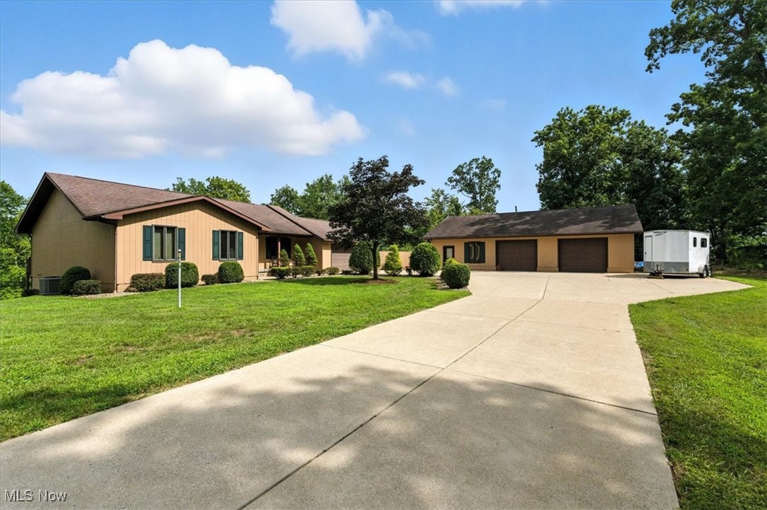 TOWN AND COUNTRY PRIVATE RETREAT..............4.46 acre setting of serene countryside. All cedar construction features woodland views throughout this TOTAL ONE FLOOR living concept. This must see home features handsome architecture in cathedral ceilings, wood floors, eat in kitchen with dining bay, 3 or 4 bedrooms and full walk out lower level with rec room. Two car attached and 50x36 detached garages with full bath, kitchenette and work room. Upgraded condition include NEWER appliances and HVAC. This desirable location is minutes from schools, hospitals, shopping and interstate. Did I mention owls, deer, songbirds and beautiful trees! Pre-listing home inspection and HOME WARRANTY.