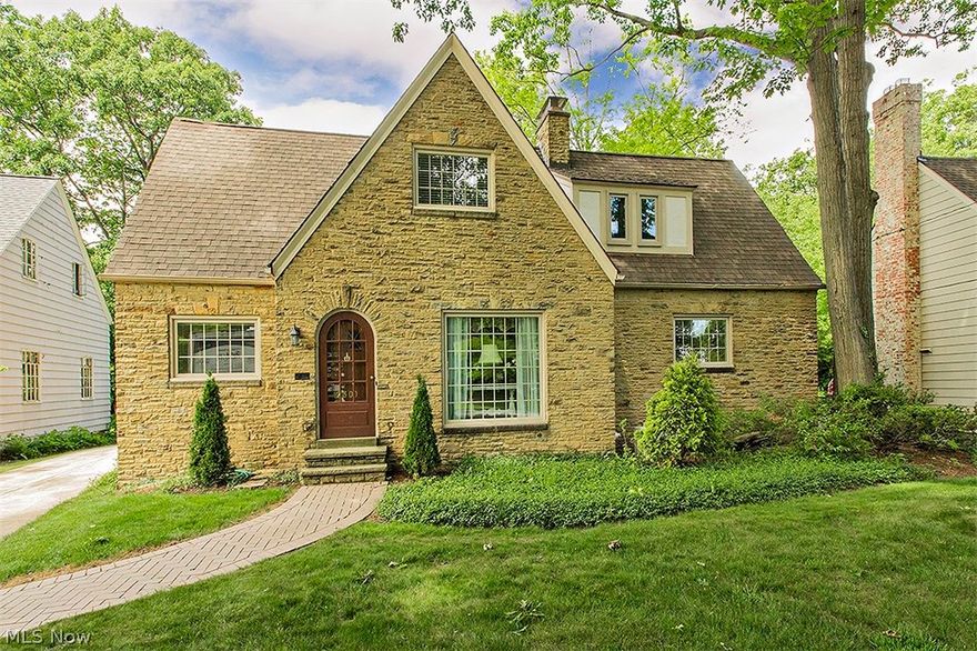 Brick & Stone English Tudor Cottage! Spacious living room with gas fireplace, crown molding and floor to ceiling window. Dining room with leaded glass cabinet, crown molding. Rustic country kitchen. Family room or eating area. Master bedroom with fireplace, 2 closets. Hardwood floors under carpet. Marvin replacement windows. 90% efficiency furnace. Rear facing attached garage with ample storage. Spacious, open backyard in park like setting.  Enclosed back porch. Close to shops, John Carroll Univ., University Circle cultural hub. City compliant.