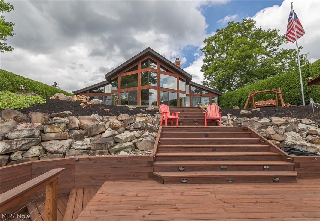 Welcome to your Dream Home. Truly a one of a kind Custom A-frame home designed by the late  architect, Jack Bialosky Sr. Steel framed ( no beams) features Glass on Glass construction. Provides panoramic floor to ceiling views from almost anywhere in the home. Fully furnished is being sold Turn Key, just bring your tooth brush & swimsuits. Two story cedar ceiling in great room. Cedar ceilings throughout the home provide a lodge style ambiance. Open floor plan allow easy entertaining blending indoor and outdoor space.  The remodeled kitchen features SS appliances, Granite counter tops & tiled back splash. Porch has EZ-glide vinyl/screen  windows providing almost year round use. The Master suite w/vaulted ceilings, large walk in closet and a glamour bath w/ walk in shower, jacuzzi, and double sinks . Loft has large enclosed storage area, (2) generous bedrooms w/ built in dressers &  full bath round out the second floor. Outdoor space includes large patio, multilevel decks, full concre