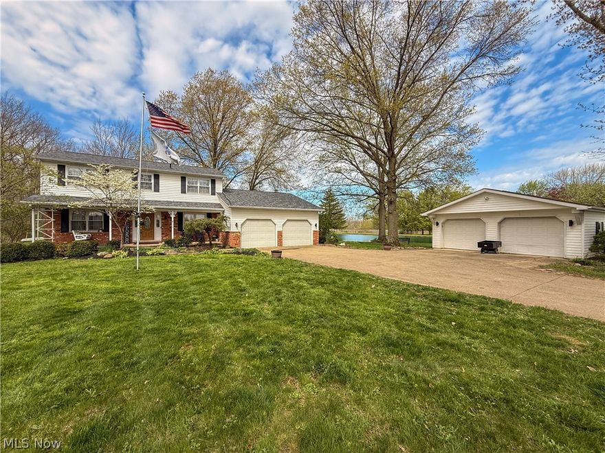 NEW ROOF! Recently finished basement! An exceptional opportunity in Valley City, this 5.55-acre property spans two parcels and features a private lake, offering a rare combination of space, privacy, and natural beauty. Enjoy a tranquil setting with convenient access to local dining, shopping, parks, and community events, all within the Buckeye Local School District. This unique property features a 2-car attached garage, a 2-car detached garage, and an additional outbuilding perfect for a she-shed, man cave, or workshop. A private small lake creates a serene, picturesque backdrop that truly sets this home apart. Inside, the updated kitchen showcases granite countertops, white cabinetry, hardwood flooring, recessed lighting, stainless steel appliances, and a new stove (2024). The kitchen opens to the family room with hardwood floors and a brick wood-burning fireplace, creating an inviting space for everyday living and entertaining. Just off the family room is the sunroom overlooking the lake, offering a peaceful spot for morning coffee or evening relaxation, while the deck extends your living space outdoors to enjoy the surrounding acreage. Formal living and dining rooms provide additional space for gatherings, while the first-floor laundry, half bath add convenience and functionality. Upstairs, the primary suite includes a private bath, along with three additional spacious bedrooms and a second full bath. The recently finished basement adds valuable additional living space, perfect for a rec room, home office, or gym. Major updates include a brand new roof (April 2026) and a furnace installed in 2022, offering peace of mind for years to come. A rare opportunity to own acreage, water views, and privacy in historic Valley City—while still being close to everything.