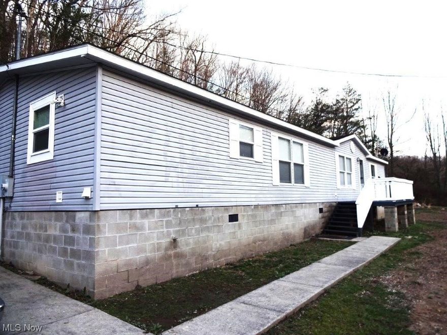 Well maintained 3 bedroom, 2 full bath manufactured home, 3.52 acres. Nice kitchen with breakfast bar, dining room, living room, great room (gas fireplace), laundry room, concrete driveway, 4 car oversized (30x40) garage, 14ft double door, 16ft ceilings, upstairs unfinished garage apartment with studded walls ready to finish, porch. Concrete parking pad for 6 cars. City water. Septic. Short drive to Charleston. Great views, nice home & garage, great country location. A must see!