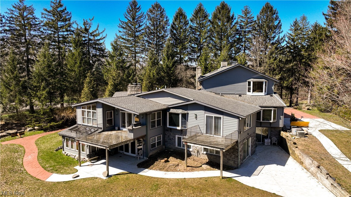 Disability ready home complete with two elevators! Here's your chance to finish your own rehab. This large mid-century modern home on a private lot with two ponds (one shared with neighbor) has an owner's suite that's more than 1,400 sq ft! Vaulted ceilings in many rooms, fireplaces everywhere (6 total), and an open floor plan between kitchen, dining room, living room, and family room! Completed work includes an addition to the kitchen, new roof, land has been cleared and leveled, and a hot tub and indoor pool with new plumbing and liner. Enjoy warm summer nights on one of the three balconies/decks. Accessibility features make for easy living with two elevators, widened doorways, and gentle slopes instead of stairs outside. The owner's suite is reachable by elevator. Did we mention the heated driveway? Come see what you can do with this incredible opportunity. Cash only, kitchen is gutted.