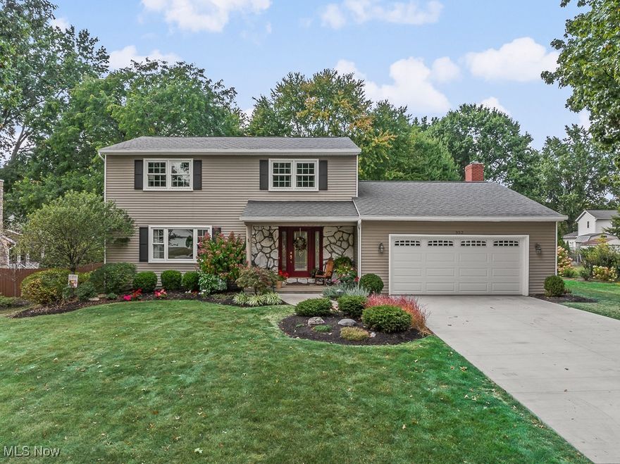 This beautifully maintained two-story Colonial blends timeless charm with thoughtful, high-quality updates. Nestled in a well-established neighborhood with mature trees and a strong sense of community, the home offers comfort and style and is just minutes from downtown and local conveniences. A new concrete driveway and garage door enhance the home’s curb appeal, leading to the two-car attached garage. At the front, a vibrant covered porch welcomes you inside. Here you'll find a warm interior where maple hardwood floors flow through much of the main level, setting a tone of natural elegance and craftsmanship. At the heart of the home is a thoughtfully expanded and remodeled kitchen designed for connection and everyday ease. Custom birch cabinetry, a large center island, peninsula seating, stone countertops, and an adjoining dining area create a space that’s both functional and beautiful. Natural wood tones and abundant light give the entire first floor a warm, connected feel. A bright front living room offers a peaceful retreat, while the cozy back family room with a woodburning fireplace opens to a spacious three-season room that flows onto a stamped concrete patio overlooking the tranquil backyard. Back inside, a refreshed powder room completes the main level. Upstairs, you’ll find four generous bedrooms and two renovated full bathrooms, including a private ensuite in the primary bedroom. A laundry setup in the primary suite adds everyday convenience and complements the main laundry area in the basement. The basement offers versatility, includes a crawl space, and is great for storage, hobbies, or future finishing. With fresh interior and exterior paint, updated appliances and systems, and a rich history of consistent care, this home reflects the pride of its longtime owners who have truly cherished living here. They love this home and hope you will, too!