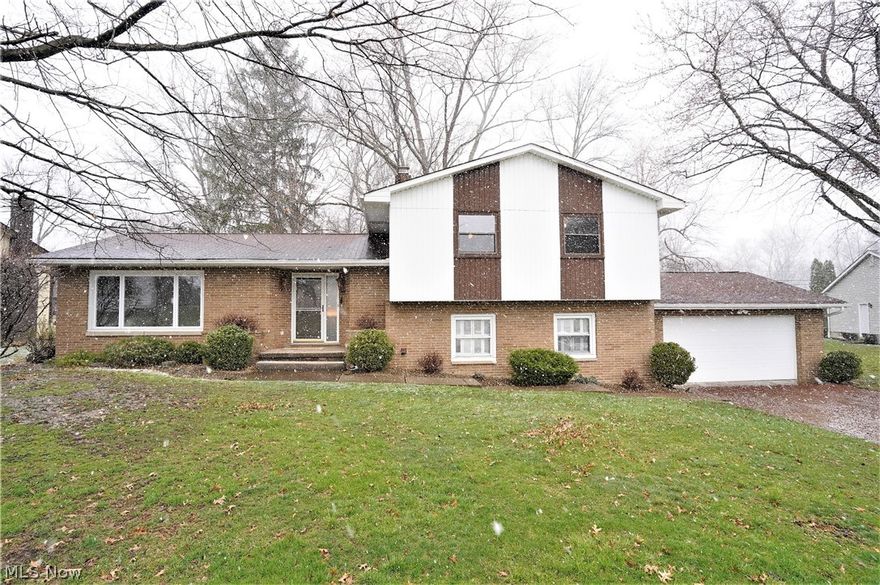 Fabulous location across the street from Marian Lake. Such a phenomenal setting surrounded by trees.  Many recent updates include interior painting throughout, carpeting and wood laminate flooring. This spacious home boasts over 2,300 square feet. The front entryway has a balcony that overlooks the lower-level 2-story dining room that has patio doors to the rear deck. There is an oversized living room that opens to the lower level. A family room in the lower level offers a fireplace, surrounded by stone, and adds to the places that would be ideal to entertain or simply relax in. The kitchen has lots of cabinets and countertop space. Laminate flooring was recently installed. Off the lower-level family room is a 3-season sunroom with a ceiling fan. The sunroom has a fantastic view of the private backyard. The laundry room/utility room has cabinets installed on one wall. The upper level has 4 bedrooms and 2 full baths. 3 of the bedrooms have ceiling fans. Vinyl replacement windows. Woodri