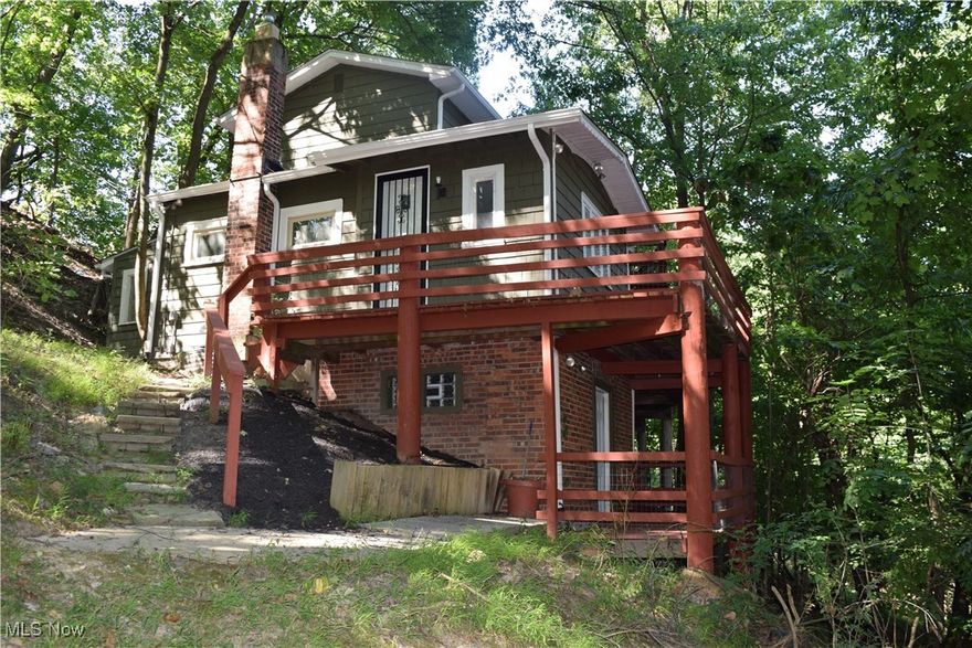 Discover the perfect blend of privacy and modern living in this beautifully remodeled 2-bedroom, 2-bathroom home. Nestled on a quiet hill with no immediate neighbors, the property offers a park-like setting just minutes from the conveniences of city life. Nothing to do but hang your clothes as the home comes fully furnished! Completely renovated with updated finishes in 2024-25, including a modern kitchen with new cabinets, stone countertops, and sink. Stylish bathrooms and comfortable living spaces designed for today's lifestyle. New roof and gutters; interior and exterior of house has been painted; basement tuck pointed and painted with dry lock on the floor; new roof and siding on garage; deck has new boards and paint; new paver walkway, new landscaping and mulch; additional graveled parking area added; new stairs to the 2nd floor; new upstairs bathroom floor; septic system pumped and inspected in 2024. Whether you are enjoying the serene views of the surrounding greenery from inside or having coffee on the wrap-around deck, this home is a unique mix of seclusion and convenience in a prime location. *2nd empty lot next door included in sale! Call agent for a private showing.