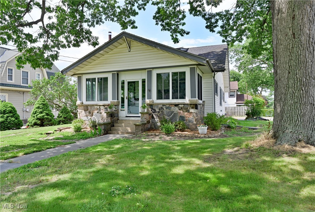 Welcome Home! Beautiful Craftsman-style home-nestled on a charming, well-established street in Amherst. Stepping into the inviting breezeway-you'll feel right at home. Spacious entrance leads you to a new kitchen, new cabinets, new countertops & new built-in large closet/pantry, new flooring. Brand new half bath with pedestal sink was added. A butlers swing door leads to dining room with built-ins including a buffet & a bay window with extra storage under the bench seat. This is the perfect spot to curl up with a book or just enjoy the beautiful wood finishes. The wood columns separating the living and dining room provide a secret secretary and a bookcase. Built-ins showcase the home’s timeless character. Spacious living room has decorative fireplace. Off the living room -is an office/music room. Throughout the main level you will find gorgeous wood trim, coffered ceilings, hardwood floors, period appropriate paint & wallpaper friezes that creates a warm, inviting atmosphere. The primary bedroom is located on the first floor with its own new bathroom. The second floor has 3 comfortable bedrooms & updated full bath. Under-eaves attics offer additional storage & the basement provides even more room. Spacious & relaxing enclosed front porch. Step outside to the extra lot & sideyard. New sandstone patio hardscaping provides a perfect space for relaxation/entertaining. The flowerbeds include pollinator friendly native plants & behind the garage containers of vegetables await the new owners. Roomy attached 3-car garage comes with additional storage and electricity. In addition- major upgrades include - high efficiency furnace, central air, hot water heater, gas line & new plumbing lines. Owners have lovingly updated this home, making it the perfect place for you to move in & enjoy. This beautiful home is within walking distance of downtown Amherst with shopping, restaurants, 5 blocks from the public library & less than a block from the Maude Neiding City Park.