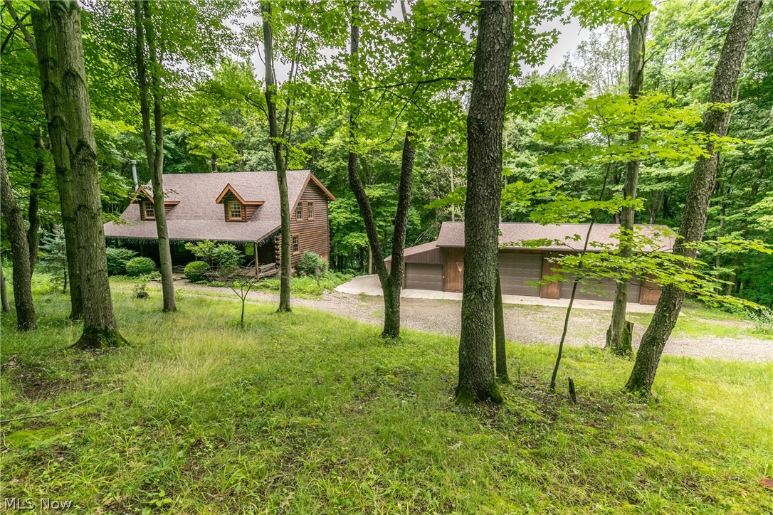 Beautiful Log Cabin tucked away on almost 8 acres of wooded property!! Gorgeous open concept living in a serene setting, this home has loads to boast about including a welcoming front porch for relaxing, a huge family room with soaring ceilings, Large kitchen with center island and appliances, First floor owner's suit with huge walk in closet and 2 large bedrooms and a full bath up!!
The property is absolutely amazing with tons of woods and privacy!! Large outbuilding/garage has car lift and plenty of room for your toys!! You've got to see it to believe it!! New roof 2020! Make your appointment today!!