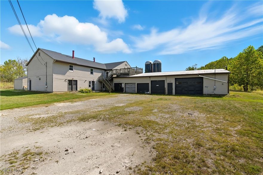 Huge opportunity with this spacious 4,760 sqft, 9-bedroom home set on 5 acres with a pond, offering versatility and room for everyone. Over 23 total rooms! This property can easily be enjoyed as a single residence (current use) or reconfigured back into four separate units, - including a studio, 2-bedroom, 3-bedroom, and 4-bedroom layout, - making it ideal for multi-generational living or investment potential. In addition to 9 large bedrooms, there are four full bathrooms (two on the upper level and two on the ground level) plus an additional half bath upstairs. Public water service and a septic system with drain field are in place. Large multi-bay garage on the inside with plenty of room for all hobbies. With its generous space, flexible floor plan, and solid amenities, this property offers a rare chance to create exactly what you need, from a large family home to a multi-family investment.