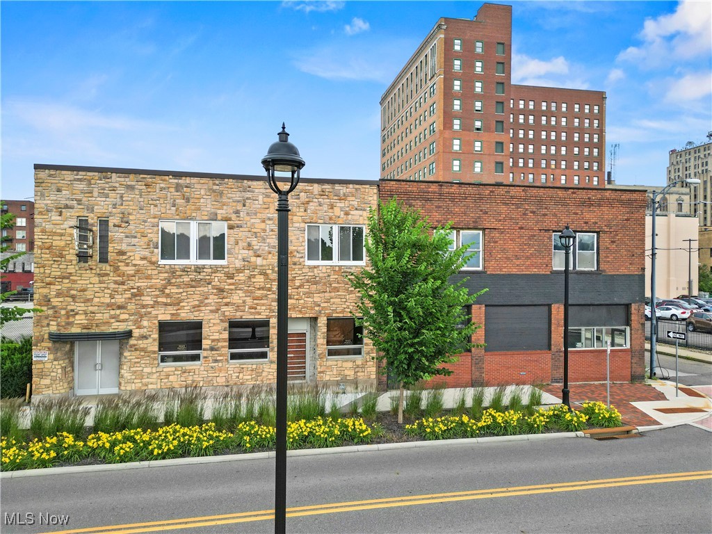 This beautiful pair of brick buildings offers so much potential! They face the Youngstown Foundation Amphitheater and Mahoning River and are in close proximity to the Covelli Center. This amazing space is right in the hub of Downtown Youngstown activity. Entertainment central! Think tavern or restaurant or retail business. Perhaps a coffee shop and bakery? The seller has opened the wall between the two buildings already and is adding a luxury loft condo space on the second floor. The parking lot can accommodate 30 cars, and public parking is across the street. 11700+ space and a basement, not to mention a decent sized garage as well. The city bike lane is in front of the buildings and the Student Corridor to YSU is right at the door too! Take notice of the new lanterns, lovely landscaping, brick walkways and crosswalk. A 7 Day all liquor license is available. Call us today to see this wonderful opportunity to be a part of the economic growth and revitalization of Downtown Youngstown.