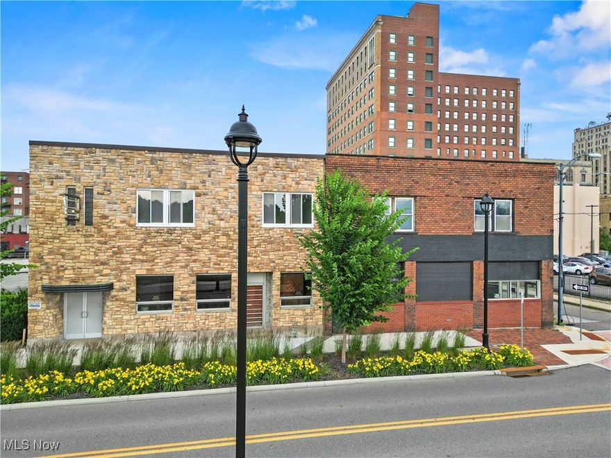 This beautiful pair of brick buildings offers so much potential! They face the Youngstown Foundation Amphitheater and Mahoning River and are in close proximity to the Covelli Center. This amazing space is right in the hub of Downtown Youngstown activity. Entertainment central! Think tavern or restaurant or retail business. Perhaps a coffee shop and bakery? The seller has opened the wall between the two buildings already and is adding a luxury loft condo space on the second floor. The parking lot can accommodate 30 cars, and public parking is across the street. 11700+ space and a basement, not to mention a decent sized garage as well. The city bike lane is in front of the buildings and the Student Corridor to YSU is right at the door too! Take notice of the new lanterns, lovely landscaping, brick walkways and crosswalk.  A 7 Day all liquor license is available. Call us today to see this wonderful opportunity to be a part of the economic growth and revitalization of Downtown Youngstown.