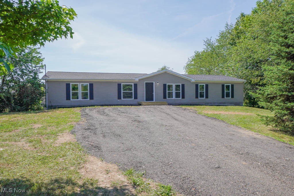Set far back from the road in a private setting, this updated three bedroom, two bath home sits on 6.24 acres and has everything you've been looking for! The bright and spacious living room features new LVP flooring that continues into the kitchen, complete with granite counters, stainless steel appliances, new cabinetry, and a center island with counter seating. The adjacent dining area includes a patio door that opens to a deck, perfect for grilling and summer meals, with the laundry room conveniently nearby.
Down the hall, all three bedrooms have fresh carpet, including the primary suite with a barn door leading to a private bath with a tiled step in shower. The other two bedrooms share a new full bath with a tub and shower combo. A full walk out basement offers plenty of storage and potential for future living space.
Outside, you'll find a fenced yard, detached two car garage, and a peaceful setting surrounded by farmland and shaded by mature trees. There’s room for a garden, pool, or additional outbuildings to suit your needs. Located in the desirable Louisville school district, with updates throughout including a new roof, windows, furnace, A/C, hot water tank, drywall, doors, paint, flooring, lighting, and more. Don't miss out, call today!