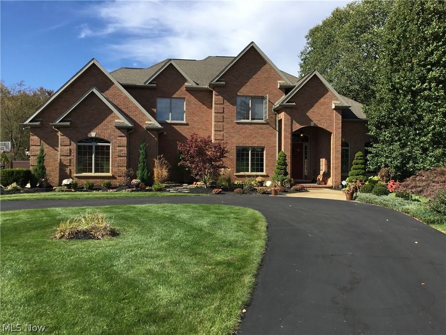 One of a kind home tucked away in a residential neighborhood on a private, 5.5 acre cul-de-sac lot. This is truly an amazing property on the inside and out. The brick construction and quality finishes can not be duplicated for this price.  Soaring ceilings, walls of windows, amazing hearth room with fireplace and built-in bookcases are just the beginning of this home.  The 1st floor master suite features his and hers closest and large bath with tile shower, soaking tub and double vanities.  The first floor office offers floor to ceiling bookcases and wonderful views of the wooded side yard.  There is also a spacious formal dining room, drop zone area with cubbies off the 4 car garage and an amazing laundry room.  The kitchen has all of the bells and whistles including double pantries and beautiful cabinets and countertops with large center island.  It is open into the hearth room and large eating area which all overlook the amazing fenced in back yard with pool and stunning hardscape.  Upstairs you will find 1 bedroom with a private bath and 2 other spacious bedrooms that share a jack n jill bath.  The walk out lower would be a great in-law suite with second kitchen area, office or 5th bedroom, full bath and family room/gaming area with fireplace.  The lot includes some woods for privacy plus plenty of yard for entertaining. Cat5 network wiring, RG6 cable, surround sound speakers, instant hot water, smart home security and zoned thermostats, 2 sprinkler systems, 20x40 pool