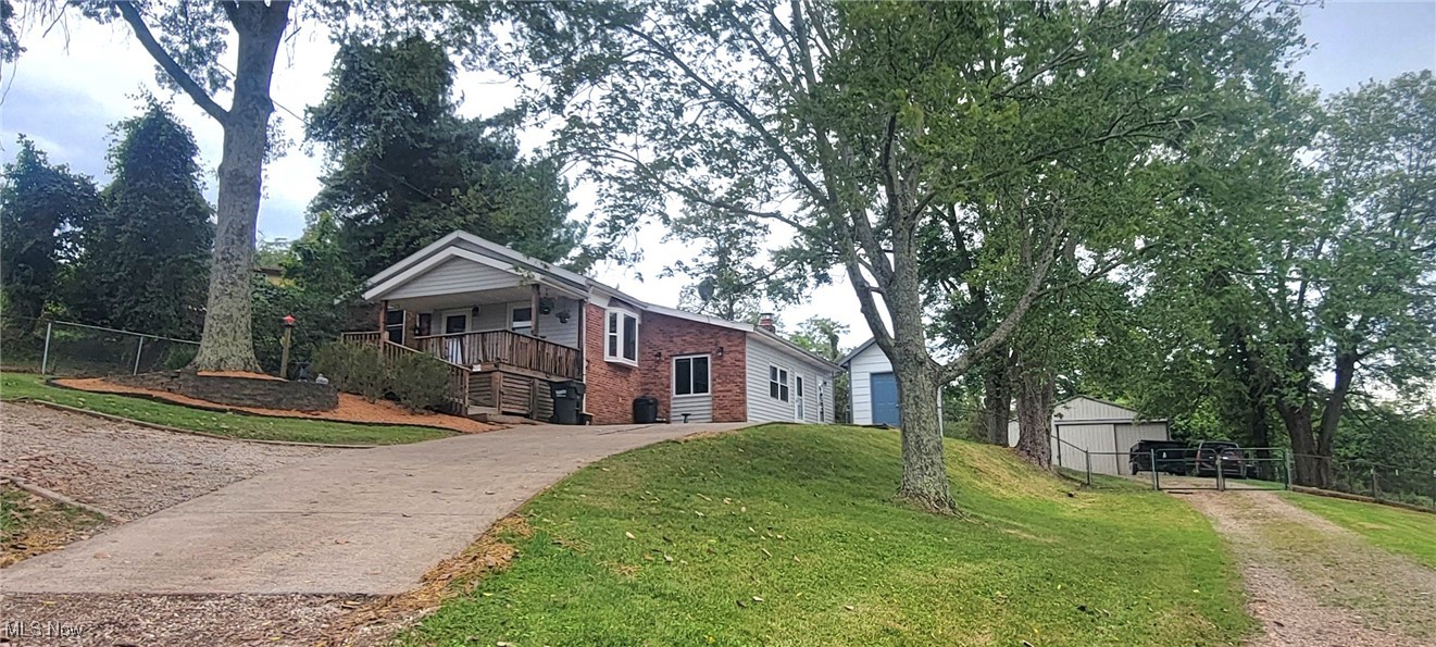 This 10-acre property a hop and skip to Belpre and minutes from Parkersburg. On the front of the home is a large porch with lots of shade from the surrounding trees. From the porch you go into the bright and airy living room with a bay window with a great view
A step up is the eat in kitchen that is been updated with newer cabinets, granite countertop, stainless steel appliances, oak trim. Also, there is a pantry in the kitchen. Off the living room is 3 bedrooms, an updated bathroom, small room with the furnace, water softener and the current owners use it for an office space. Stepping down a few steps from the living room is a cozy family room with a wood stove with natural light coming in, also a room for the washer, dryer and hot water tank. Moving outside there is a small storage shed, fenced in big back yard. 30x40 pole building that does have some fencing for the animals. There is some pasture for the animals and woods for the hunters. There is 600 ft of road frontage. If you're wanting to be close to the amenities but want a country setting this is the place for you