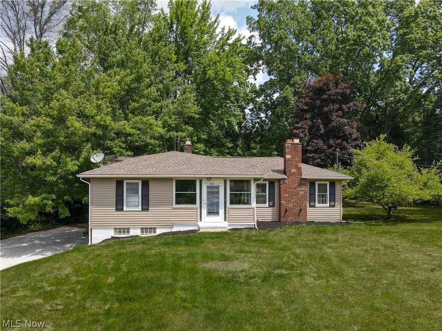 Welcome to 375 Eastwood Ave, a cute ranch style home perfectly situated on a private three and a half acre lot in beautiful Tallmadge Ohio. Enjoy living next to nature but yet close to many of the amenities offered with city living. Minutes from shopping, dining, schools, Goodyear Heights Metro Park, highway access and much more. The current owners have lovingly added many updates to the home including new roof (2013), siding, gutters, downspouts (all 2019), garage door (2016), and exterior side stair case (2021). And on the inside, new wide plank pergo floors, light fixtures, trim, fresh paint, and a completely remodeled full bathroom in the basement. The main level offers three good size bedrooms, a full bathroom, formal dining room, a spacious family room that is flooded with natural light from the large windows and boasts a gas fireplace. Newer stainless steel appliances in kitchen (2016). One of your favorite rooms will surely be the enclosed sunroom off the back the home overlook