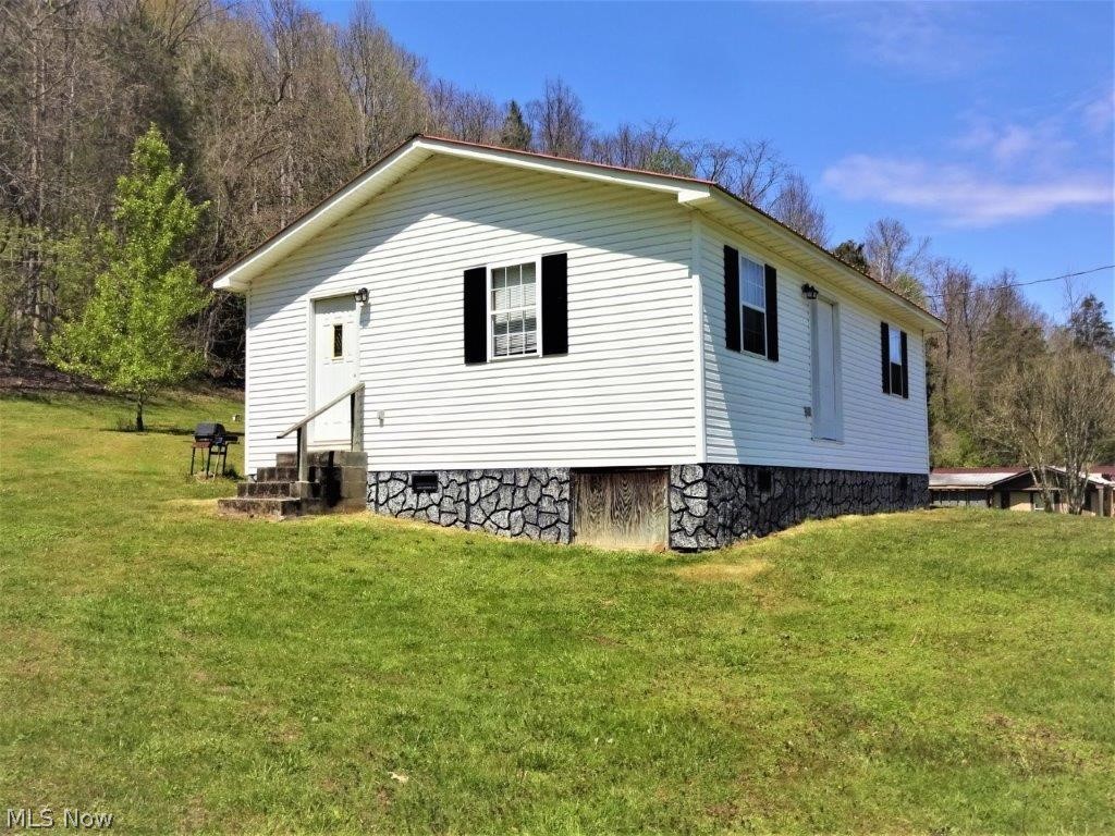 68.10 surveyed acres with nice country home built in 2002. Home features 2 bedrooms, 1 bath, country kitchen, living room, laundry room. Central heat/air. Large yard. 8x10 outbuilding with electric. Reduced gas rate. Garden area. Good water well & septic. Excellent hunting - deer, turkey, rabbits, squirrels, occasional bear. Tree stands convey. Perfect county location! Paved road frontage, short drive to Cedar Creek State Park (2600 Acres). Enjoy the Wild Wonderful West Virginia country life. 15 miles to Interstate I-79.