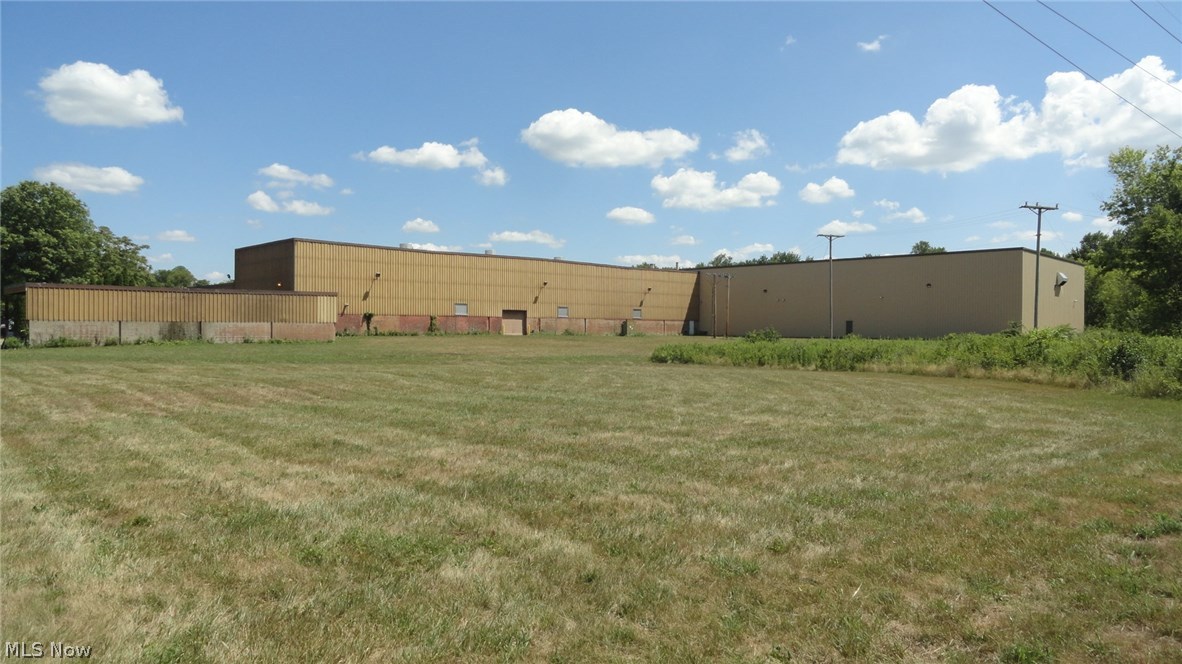 122,000+/- sq. ft. industrial building with separate office complex. The 8,716 sq ft brick office area has 16 offices, bull pen area, 2 conference rooms, 3 restrooms and gas forced air heat and central air. The 113,396 sq ft industrial area has 16' to 31' ceilings and radiant heat. There are 4 restrooms, locker room with showers, a 26 x 12 conference room with kitchenette and shop area. There are four 16' overhead doors (1 inside dock), two 10' overhead doors, two dock doors with levelers and 7 overhead rail cranes 10-25 ton. The paved parking area has 50+ spaces. The level 10+ acres has over 900' frontage on Robinson Drive and is located in a high traffic industrial area with easy access to St Rt 250 and I-77. Current owners pay flood insurance.