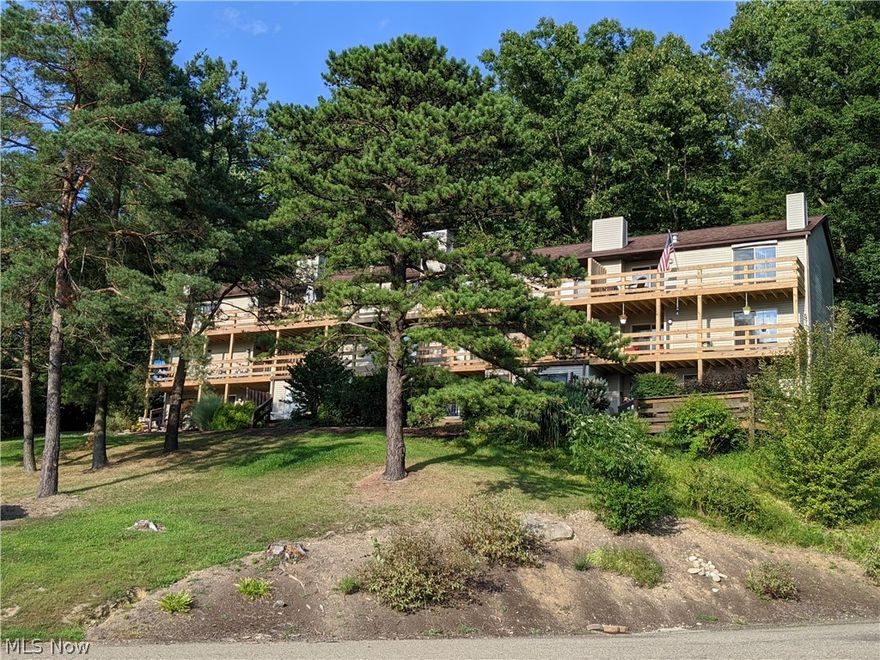 2358 Ridgeview Dr SW Sherrodsville OH 44675 in the Atwood Lake Pines area is located just across from the Atwood Yacht Club in the Muskingum Watershed District playground of water sports! This Gorgeous 2 Bedroom Condominium has some absolutely Beautiful views from the 4, yes I said FOUR, Sliding Glass Doors onto the full length 2 levels of decks running across all the rooms! Whether you are looking for a full time home or a weekend vacation home, this condo is awesome! Dock is available at either Marine or at the Yacht Club if you want!!! The condo has a newer air conditioning as well as 2 of the 4 sliders are newer as well as new decks installed in the past year! This is also a highly sought after END Unit so more privacy and area to explore. Vaulted ceilings from the open floor plan of the large Living Room, Dining Area and well laid out Kitchen with a full size set of stacked washer and Dryer for your convenience. Plenty of storage with several closets throughout. The Atwood Lake Pa