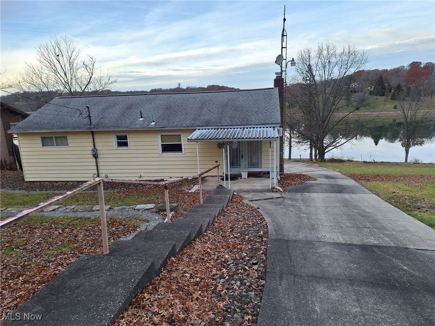 Spectacular views of the lake is the crowning jewel of this ranch style home at Lake Tomahawk in Negley Ohio.  Here you'll find a 3 bedroom ranch home with 2 full remodeled baths. Upstairs bath has a walk-in shower.  From each of the 3 bedrooms there is a patio door to the newly finished full length back deck.  The view from here is awesome! There is a 3 car detached garage as you enter the drive equipped with a door opener and A/C and it is insulated and dry walled. There is also parking for 3 additional cars at the yop of driveway . At the home there is also a 1 car garage in the basement area along with a laundry / utility room, another remodeled bath with walk-in shower and Family room with wood burning fireplace.  This area could be used as an in-law suite or a place for guests to stay. Come see what its like to live at The Lake!  Basement can be accessed from inside or outside through the rear ground level entrance.  The community at the lake offers a bait and tackle shop at the marina, a beach area with a playground, basketball courts, tennis courts and volleyball nets with a community covered pavilion to use also. Make your lifetime memories here at Lake Tomahawk. Make your appointment today for a private tour.