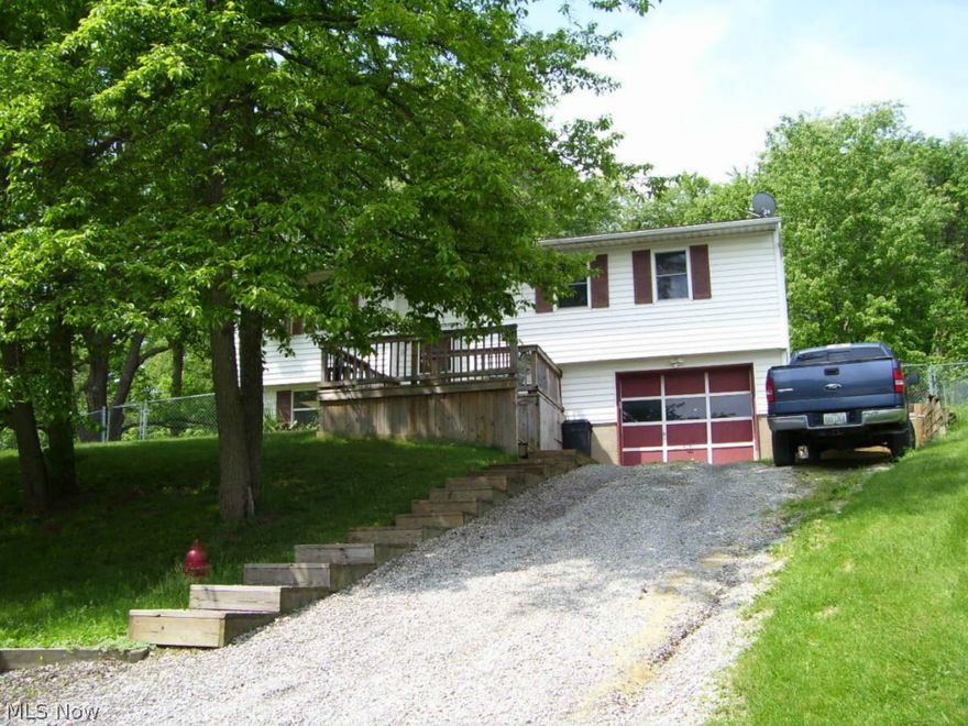 Peaceful wooded setting, private, fenced yard, extra lot, updated electric, new kitchen cabinets, and more.