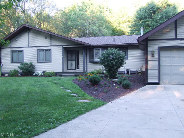 Wonderful 3 Bedroom, 2 full Bath Ranch on 1+ acre in Tallmadge, sits way off the road for extra privacy plus completely fenced backyard. Fireplaced living room and family room, sliders to deck in living room, patio off master bedroom, master bathroom. Home is complete with all OAK trim and doors, 2-car attached, heated garage, large shed with electric, clubhouse with electric. Updates within last 5 years include newer roof, siding, furnace, hot water tank, softener, insulated garage door, both bathroom vanities, sinks, faucets. Plenty of closets and storage, including attic in garage with pull-down stairs. Move in ready!! County records do not include the family room. Make this your own fortress today!