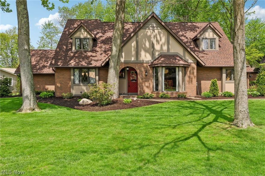 Welcome to this beautifully maintained Tudor-style home set on nearly half an acre in a well-established Wooster neighborhood, offering timeless character, flexible living space, and an exceptional backyard designed for everyday enjoyment and entertaining.

The main level features multiple inviting gathering spaces including a formal living room, formal dining room with hardwood flooring, and a comfortable family room anchored by a floor-to-ceiling stone gas fireplace with built-in desk and direct access to the back deck and patio. The eat-in kitchen with peninsula seating and stainless steel appliances connects easily to the home’s central living areas, creating a layout that supports both daily routines and hosting. Also on the main level are main-floor laundry, a convenient half bath, and a private primary suite featuring dual closets, double vanity, walk-in shower, and sauna.

Upstairs, you’ll find three additional bedrooms—including two with built-in desks—and an updated full bathroom, providing flexible space for guests, work-from-home needs, or hobbies.

The finished basement adds valuable additional living and recreation space while still offering ample storage.

Outdoor living is a true highlight of this property, featuring Unilock paver patios, natural stone retaining walls with integrated lighting, a firepit, cedar pergola, Trex decking, aluminum fencing, and a custom walnut pavilion with lighting and ceiling fans, all surrounded by beautifully maintained landscaping and thoughtfully designed for relaxing and entertaining.

The home also includes an attached 2-car garage with extended storage and workspace. Major exterior improvements include a roof (2021), gutters with leaf guards (2022), and Hardie siding and trim (2023). A pre-listing home inspection has already been completed for added buyer confidence, and a detailed Property Information Sheet outlines the many additional updates and improvements made throughout the home.