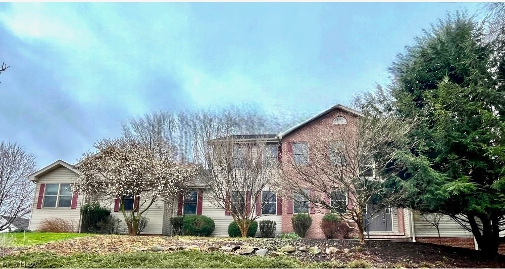 Welcome home to 630 Rustic Knoll in the sought after neighborhood of River Bend in Kent! Situated on over .8 acres, this stunning home has everything you are looking for. Located on a cul-de-sac and surrounded by mature trees and nature, the surroundings are serene and peaceful. You are greeted in this home by amazing wood flooring throughout the first floor, an impressive two-story foyer and a soaring vaulted ceiling in the family room! The family room is flooded with natural light and centered by the gas fireplace. The eat-in kitchen has tons of counter space and cabinets, including a large kitchen island, stainless steel appliances and built-in shelving. The library is spacious and bright and leads directly down to the first-floor primary suite. The primary suite is an oasis of tranquility and relaxation with three walk-in closets, full bathroom with soaking tub, and a large sunroom with walls of windows, skylights, and a vaulted ceiling. The first-floor laundry room and additional bonus room round out the first floor. Upstairs has all new carpet (2024) and three large bedrooms with ceiling fans and oversized closets, and another primary suite! The second-floor suite has dual walk-in closets and a huge full bathroom with dual vanity, soaking tub, and standup shower! In addition to the close to 4,000 square feet of above ground living space, there is an additional 1,500 square feet of finished living space in the walkout lower level. The lower level has multiple recreation rooms, fireplace, bar, full bathroom and an additional bedroom/office. The backyard has an expansive deck overlooking the large yard, in addition to a paver patio located right outside of the walkout lower level. The 4-car garage is ideal for multiple cars, storage and wood-working. This home is ADA accessible with no stairs at all on the first floor, and a ramp from the garage to the home. Do not miss out on this opportunity to own an amazing property in the heart of Kent!