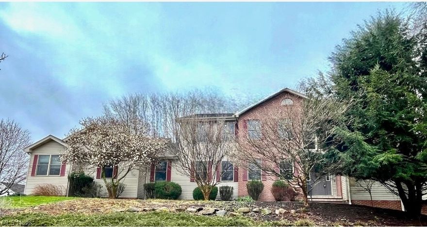 Welcome home to 630 Rustic Knoll in the sought after neighborhood of River Bend in Kent! Situated on over .8 acres, this stunning home has everything you are looking for. Located on a cul-de-sac and surrounded by mature trees and nature, the surroundings are serene and peaceful. You are greeted in this home by amazing wood flooring throughout the first floor, an impressive two-story foyer and a soaring vaulted ceiling in the family room! The family room is flooded with natural light and centered by the gas fireplace. The eat-in kitchen has tons of counter space and cabinets, including a large kitchen island, stainless steel appliances and built-in shelving. The library is spacious and bright and leads directly down to the first-floor primary suite. The primary suite is an oasis of tranquility and relaxation with three walk-in closets, full bathroom with soaking tub, and a large sunroom with walls of windows, skylights, and a vaulted ceiling. The first-floor laundry room and additional bonus room round out the first floor. Upstairs has all new carpet (2024) and three large bedrooms with ceiling fans and oversized closets, and another primary suite! The second-floor suite has dual walk-in closets and a huge full bathroom with dual vanity, soaking tub, and standup shower! In addition to the close to 4,000 square feet of above ground living space, there is an additional 1,500 square feet of finished living space in the walkout lower level. The lower level has multiple recreation rooms, fireplace, bar, full bathroom and an additional bedroom/office. The backyard has an expansive deck overlooking the large yard, in addition to a paver patio located right outside of the walkout lower level. The 4-car garage is ideal for multiple cars, storage and wood-working. This home is ADA accessible with no stairs at all on the first floor, and a ramp from the garage to the home. Do not miss out on this opportunity to own an amazing property in the heart of Kent!