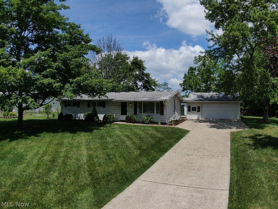 Well-maintained home in Streetsboro, next to huge Streetsboro City Park! 3 bed 1.5 bath. Newer roof, furnace and central A/C. Great curb appeal! Big, lush, shady lot. Sprawling front lawn. Long driveway to 2 car attached garage. Extra parking spaces. This house is warm and comfortable w gorgeous wood paneling and nostalgic, pretty wall paper. Large living room w vaulted ceiling. Huge, carpeted, eat-in kitchen w ceiling fan, wainscoting, chair rail, and a ton of storage. Laundry room. Bright bedrooms are large. Beautiful tile bathroom w walk-in shower and separate tub. Newer concrete patio area. Special backyard! Hwy 14 is a convenient 1 block away. This attractive home can be enjoyed as is, or upgrade it to match your dreams. It’s priced to sell!