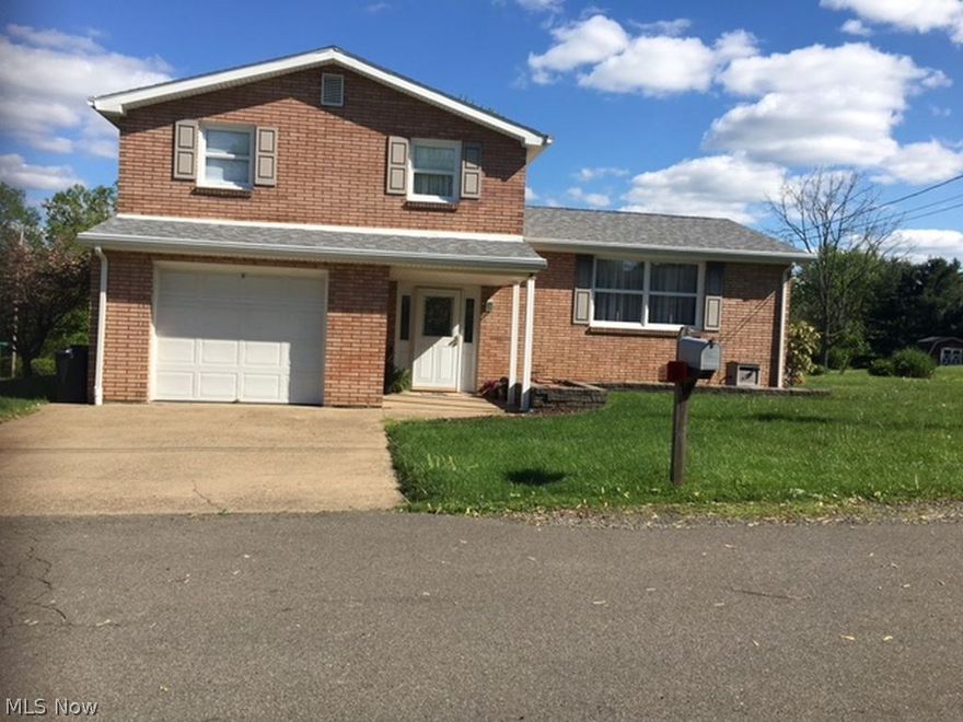 Follansbee- This split level all brick home features 3 bedrooms, 1.5 baths, formal dining room, family room and a large eat-in kitchen. Home is located on a very large flat lot.  A great home for entertaining. Covered back patio is a great spot for relaxing and enjoying the beautiful wooded area. Pristine condition. Don't wait to view.