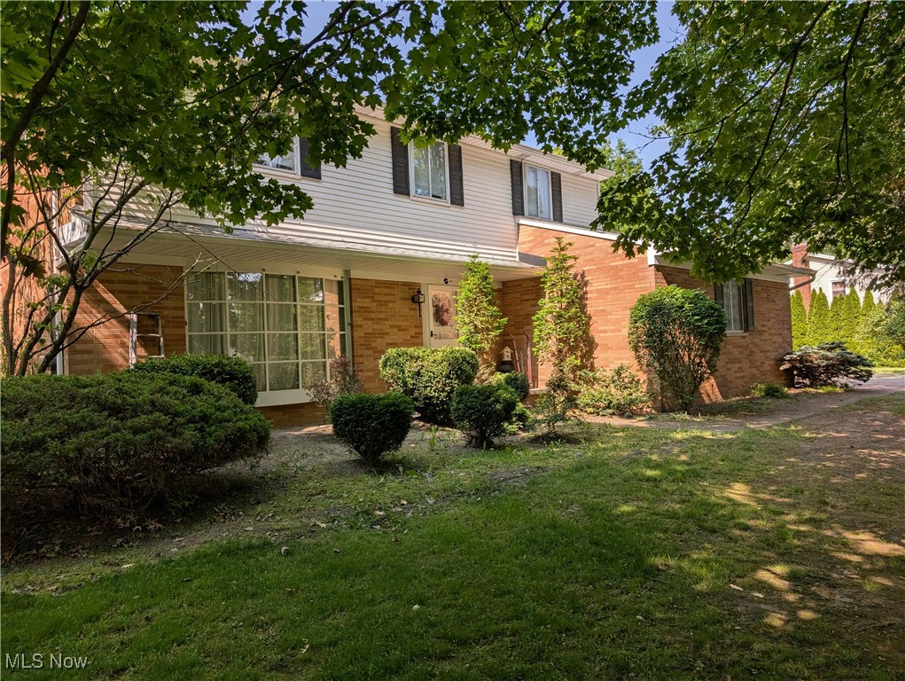 Charming brick colonial nestled on two beautiful lots (almost 3/4 ac.). This home features 5 bedrooms with 2.5 baths and a huge 3-season room overlooking the fenced rear yard with a walkout to a covered patio. The country kitchen provides the much needed cabinetry with great counter space. The focal area is the comfortable family room with fireplace adjacent to the kitchen and 3-season room. The home also has the formal dining & living rooms. The 5 bedrooms are located on the second floor with 2 full baths. The half bath and laundry are also conveniently located on the first floor. The unique lower level enables the new owner a drive-in garage for that special car and a spacious rec room with wet bar and a private study.