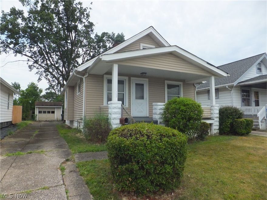 Vinyl sided bungalow, 2 bedrooms plus unfinished 2nd floor, newer windows, front porch, glass block windows, covered patio, garage
