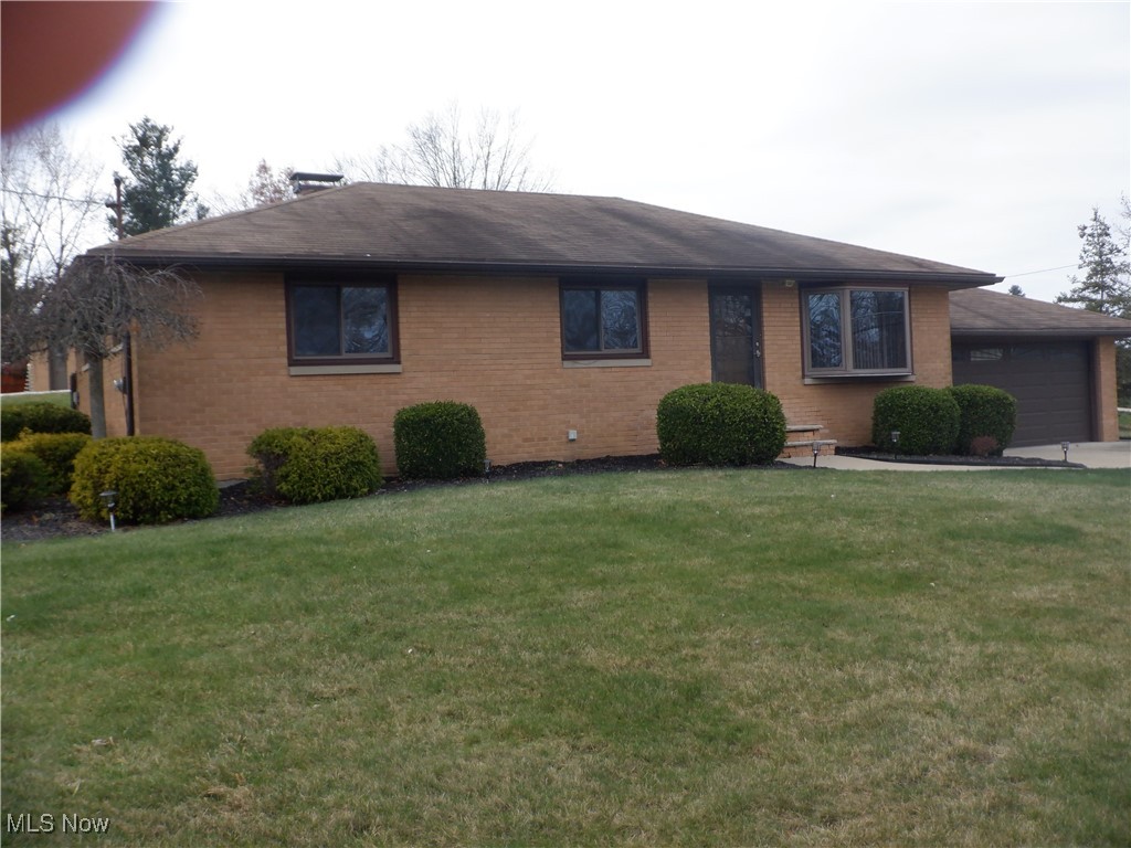 WOW! Alot to offer here. 4 Bedroom 2 full bath, Brick Ranch; close to schools; Full finished basement with a full functional kitchen, bar, full bath, laundry and an extra room, acting as a Library. 3 car wide driveway; Sliding Glass Door leading to a covered patio off the Dining Room. Extra Parking on Gravel (east side of the home)
