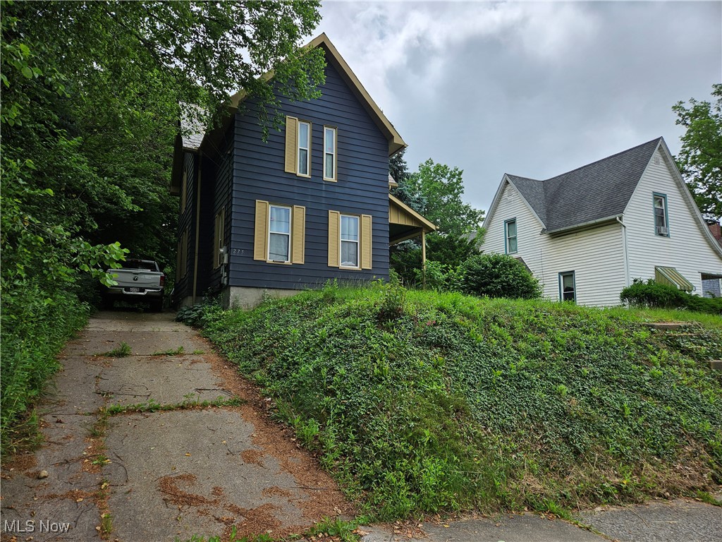 This spacious three-bedroom Colonial home is situated on a 1/4-acre lot in the heart of Wadsworth, offering easy access to downtown, shopping, schools, and more, all within walking distance. The updated eat-in kitchen features maple cabinets and a tile backsplash. The large living room boasts a wood-burning fireplace. A remodeled full bath, featuring a granite countertop, is conveniently located on the first floor, adjacent to the master bedroom. On the second floor, you'll find a roomy sitting area and loft, along with two generously sized bedrooms. Additionally, a walk-in attic space is located off one of the bedrooms, providing ample storage. Beautiful private lot, two-car garage.