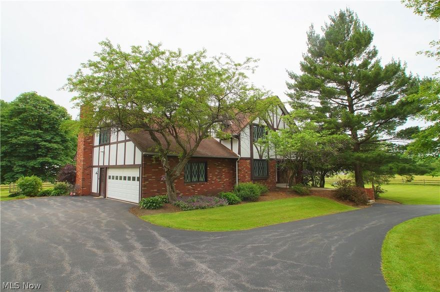 Spectacular Updated Chesterland Estate tucked away on a quiet street. This unique property features over 4200 sq ft and 5 bedrooms on over 5 private acres. The large foyer enters into a spacious and sprawling floor plan. Large newer windows throughout the home bring in a flood of natural light and overlook the park-like setting and pastures. The home features: New carpet throughout and freshly painted, a formal living room overlooking gorgeous wooded and pasture views, warm and inviting family room with beamed ceiling and wood burning fireplace, an immense master bedroom with newly remodeled master bath featuring over-sized tile and glass shower. Large bedrooms featuring Hardwood flooring, a spacious kitchen features new Stainless appliances, double ovens, and loads of  storage. Take in all the fabulous views from the deck and attached Gazebo. A 46 x 30 Horse barn features water and electric, 4 stalls, and fenced pasture with adjacent 5 acres with fenced in pasture also available. So m