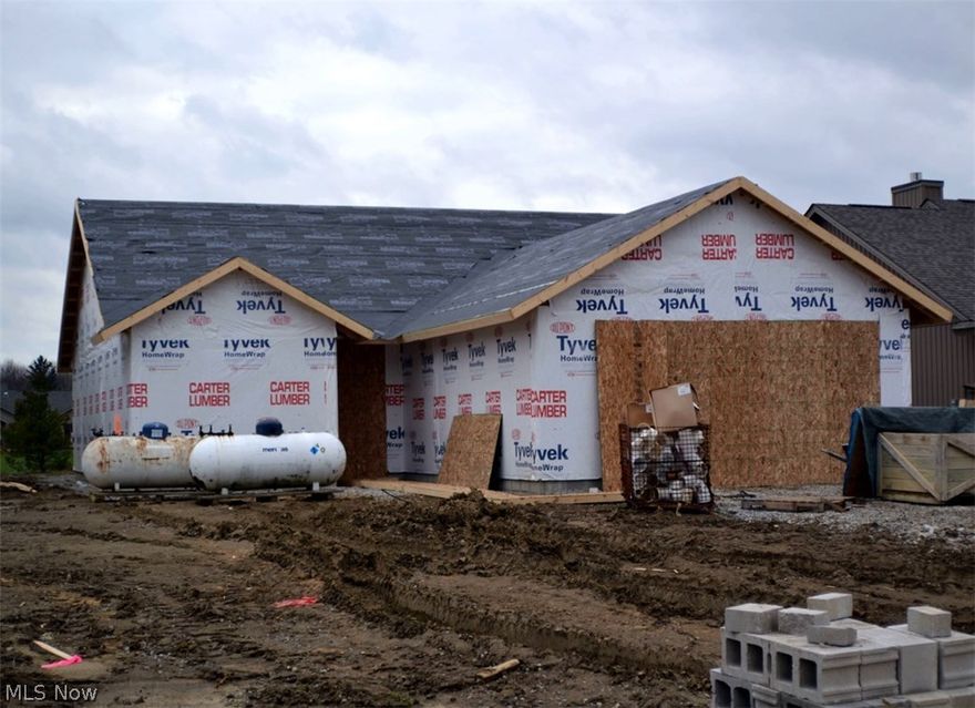 Custom home under construction.  Features include three bedrooms - master with full bath and walk-in dressing room, cathedral ceiling in great room, spacious kitchen with snack bar dining, dining room, mud room, two full baths, patio, two car insulated garage with door operator, pull-down stairs to overhead storage, hot and cold water and floor drain.  Subdivision Olympic-sized pool, children's pool, play area, clubhouse and fitness center.  Numerous single family and cluster home building sites are available.  Custom design your own home!!