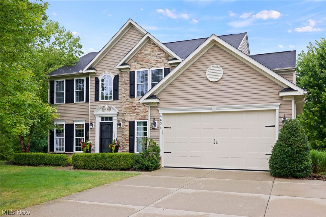 Welcome to 4497 Vista Circle, a stunning single-family home located in the desirable community of Pleasant Lakes. This classic colonial-style home offers ample curb appeal and boasts a spacious floor plan with 5 bedrooms, 3.5 bathrooms, and a host of incredible features. As soon as you step through the front door, you'll be greeted by the grand 2-story ceilings in the foyer, creating a sense of elegance and openness. The main level of the home is graced with a stylish gas fireplace with barn beam mantel in the great room and beautiful white wainscoting in the living room, adding a touch of sophistication to the space. The kitchen is a chef's dream, complete with stainless steel appliances, granite countertops, a 36" cooktop, and ample cabinetry for all your culinary needs. The adjacent morning room features vaulted ceilings, allowing natural light to flood the space. Through the double glass doors in the entryway is the dedicated office space with large windows. This property also includes a thoughtfully designed mudroom with custom built-in cabinetry, providing the perfect storage solution for coats, bags, and shoes. Upstairs, the master bedroom is a peaceful retreat, showcasing a private en-suite bathroom with a dual sink vanity, walk-in shower, and luxurious soaking tub. The additional bedrooms are also spacious in size and share the second full bathroom with a shower/tub combo & dual sink vanity. For convenience, the laundry room is also placed on the 2nd floor. Entertain friends and family in the fully finished basement complete with theater room, recreation room with a stone fireplace, and wet bar. The 5th bedroom and 3rd full bath finish off this space. Outside of the kitchen is the raised trex deck, where you can relax and unwind while the kids play on the at-home playground. The outdoor patio with Pennsylvania Blue Stone pavers and wood-burning fireplace is perfect for gathering around during cooler evenings, and making memories that will last a lifetime.