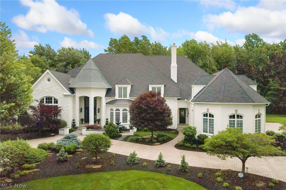 Welcome to one of the largest homes on the west side in Westlake’s Lands End. This Valore built 24,000sqft estate is located across from Lakewood Country Club & a few minutes from Crocker Park. This home has undergone many updates in the last 18 months. The exterior has been painted & the contrasting black roof & turret are brand new. A stone motor court, 4 car heated garage, & circular driveway welcome you. The foyer of this home speaks to the quality of craftsmanship you will find throughout including a carved mahogany front door, wrought iron staircase, inlay marble floor, soaring ceilings, & crystal chandeliers. The entire home has been painted Greek Villa by Sherwin Williams to bring lightness to each space. The formal dining room & piano room are combined to invite you to host. The great room is the heart of this home with 2-story windows, carved wood/marble fireplace, & fully appointed bar. Travertine floors flow throughout the kitchen, vaulted sunroom, casual living room, & dining space. The kitchen has been brought up to 2024 aesthetics with double islands, marble backsplash, solid marble farm sink, granite countertops, brass hardware, & top of the line appliances. The first floor also includes a full bedroom suite, study, 2-story library with blonde herringbone floors, 3 powder rooms, XL laundry room, & green marble elevator that provides easy access to the other levels. The second floor has been upgraded with hardwood floors. The primary suite occupies an entire wing of this level. The master bath is inspired by a luxury hotel suite with picture windows, marble vanities, soaking tub, & spacious shower. The suite also boasts coded entry walk-in closets w/ leaded doors. The basement is unparalleled with egress windows, burlwood bar, billiards space, wine cellar, movie theatre, country club poker/cigar room w/ humidor, gym, sauna, steam shower, locker room, & more. Backyard amenities include a double patio, outdoor kitchen, & new jacuzzi style pool.