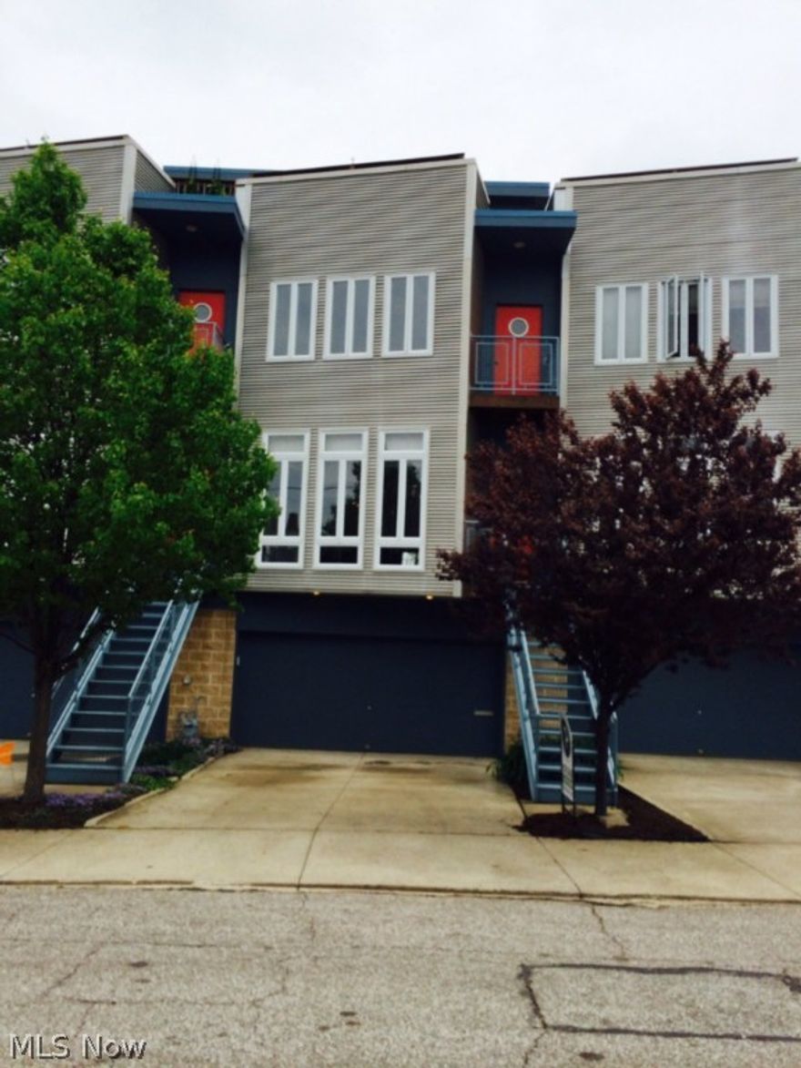 Gorgeous three story town home in Gordon Square. Main floor offers an open floor plan of the kitchen, dining and living areas with attractive bamboo floors, gas fireplace, custom recycled glass tile and honed granite counter tops. Large master bedroom has a lake view and large master bath. Second full bath, guest bedroom, office and 2nd floor laundry. Built in book shelves on ground level make for the perfect library, study or office. 2 car attached garage. Rooftop deck with lake and city views. Tax abated until 2020! Just a quick walk to Edgewater Park/beach and all the amenities Gordon Square has to offer, three theatres, 78th Street Studios, many restaurants and shops. 10 minute bike ride to downtown.